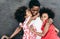 Portrait of african mother with twins sisters outdoor - Black family having fun on the beach playing together - Love, real people