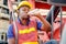 Portrait of African worker man drink water from bottle and stay on big crane truck in cargo shipping area
