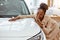 Portrait of africanamerican woman hugging new auto