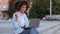 Portrait of afro american ethnic mixed race girl woman successful freelance student businesswoman sitting on steps of