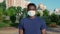 Portrait afro-american man adult in protective medical face mask looks camera