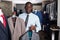 Portrait of afro-american man buyer choosing business style jacket in the shop
