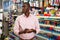 Portrait of Afro American man choosing ball pen at stationery store