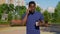 Portrait Afro-American man talking on mobile phone drinking coffee tea in summer