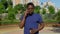 Portrait Afro-American man talking on mobile phone drinking coffee tea in summer