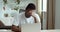 Portrait of afro american student black male tired guy wears white looks at laptop screen learns bad new feels