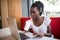 Portrait of afro american student female typing answers to friends while working on a laptop with wireless internet connection dri