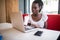 Portrait of afro american student female typing answers to friends while working on a laptop with wireless internet connection dri