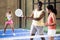 Portrait of afro american trainer teaching woman playing padel