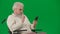 Portrait of aged disabled man on chroma key green screen. Close up senior man in wheelchair talking video call on