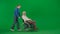 Portrait of aged man on chroma key green screen background. Young girl walks and carries senior man granddad on a