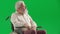 Portrait of aged man on chroma key green screen. Close up senior man sitting in wheelchair thinking, upset depressed