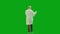 Portrait of aged man medic on chroma key green screen. Back view senior doctor in uniform walking in hospital holding