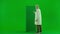 Portrait of aged man medic on chroma key green screen. Senior doctor standing at advertisement virtual screen, swiping