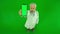 Portrait of aged man medic on chroma key green screen. Top view of senior doctor in uniform holding smartphone and