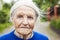 Portrait of an aged woman smiling outdoors