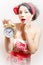 Portrait of agitated funny young brunette blue eyes pinup woman with alarm-clock looking at camera