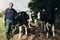 Portrait, agriculture and cows with a man on a farm outdoor for beef or natural sustainability. Confident, milk or dairy