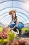 Portrait, agriculture and a farmer woman in a greenhouse for sustainability, organic growth or farming. Plant, smile and