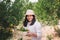 Portrait of Agriculturist Farmer Woman is Harvest Orange While Holding Wooden Basket With Big Smile in Organic Farming., Agricultu