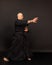 Portrait of aikido sensei master with black sensei belt in taekwondo kimono on black background. Traditional samurai