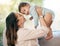 Portrait, airplane and mother with baby on a sofa for games, playing and laughing in their home together. Love, smile