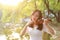 Portrait Aisan Chinese girl woman artist play violin in nature park forest enjoy leisure time performance outdoor lake sunrise