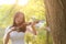Portrait Aisan Chinese girl woman artist play violin in nature park forest enjoy leisure time performance outdoor lake sunrise
