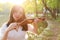 Portrait Aisan Chinese girl woman artist play violin in nature park forest enjoy leisure time performance outdoor lake sunset