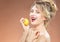 Portrait of Alluring Caucasian Blond Girl Biting Lemon