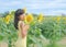 Portrait Alone Woman with Yellow Dress Standing in Sun Flowers Park and Blue Sky Background. free space for add text presentation