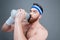 Portrait amazed bearded sportsman drinking water