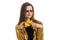 Portrait of amazing brunette in glasses and a gold jacket that keeps in the hands of bananas