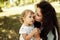 Portrait of amazing mother with cute little daughter walking in the forest. Family concept.