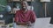 Portrait of ambitious African American man smiling enjoying successful career sitting in office