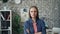 Portrait of ambitious independent woman standing in office with arms crossed