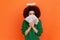Portrait of angelic woman with Afro hairstyle wearing green casual style sweater and nimb covering