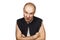 Portrait of angry bald man aggressive thug threatens. Concept portrait of a dangerous criminal on an isolated white background