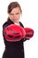 Portrait of angry businesswoman with boxing gloves punching isolated on white background