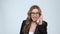 Portrait of angry businesswoman shouting in white phone on gray background, slow motion.