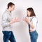 Portrait of an angry couple shouting each other against white background