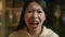 Portrait angry crazy Asian chinese woman shout open mouth shouting irritated emotion screaming aggressive japanese