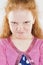 Portrait of Angry and Furious Little Caucasian Redhaired Girl