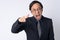 Portrait of angry Japanese businessman shouting and pointing at camera