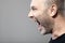 Portrait of angry man sreaming isolated on gray background