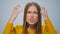 Portrait of angry woman screaming with aggressive emotion at camera in studio.