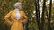 Portrait of annoyed blond woman in the park waiting for someone and looking around