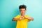 Portrait of appreciative small boy with curly hair wear stylish t-shirt fingers show heart symbol isolated on turquoise