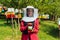 Portrait of Arab investitor in the beekeeping department of a honey farm holding a jar of honey in her hand