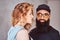 Portrait of an Arabian bearded male and beautiful redhead girl.